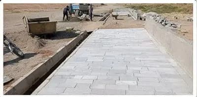 عملیات کفسازی وسنگ فرش پیاده رو ضلع جنوبی پارک شهید مدرس